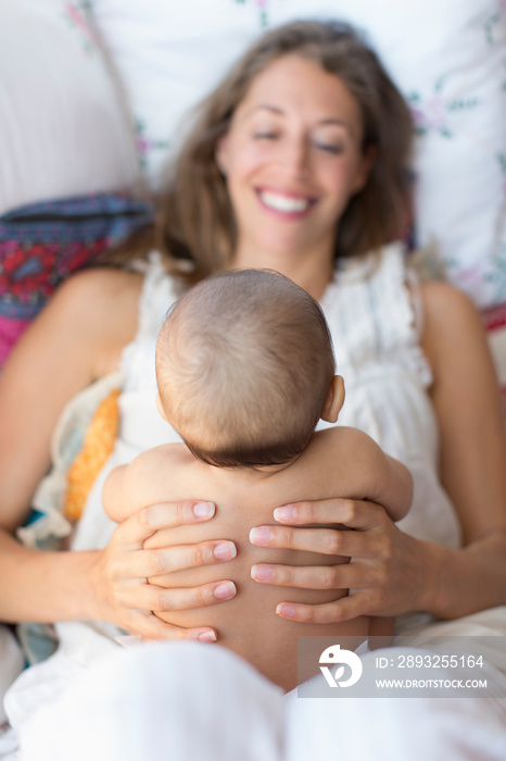 Happy mother holding baby son