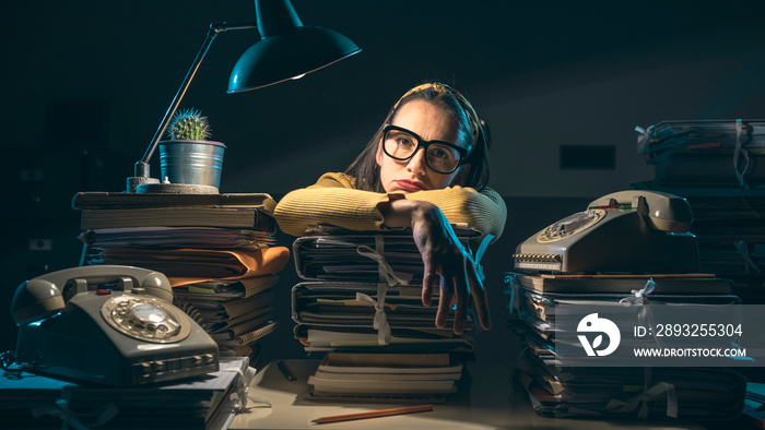 Businesswoman overloaded with paperwork