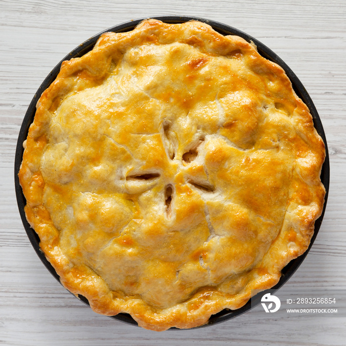 Homemade american apple pie dessert on a white wooden background, top view. Flat lay, overhead, from