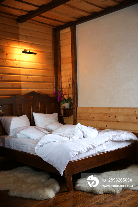 Detail of mountain wooden lodge bedroom