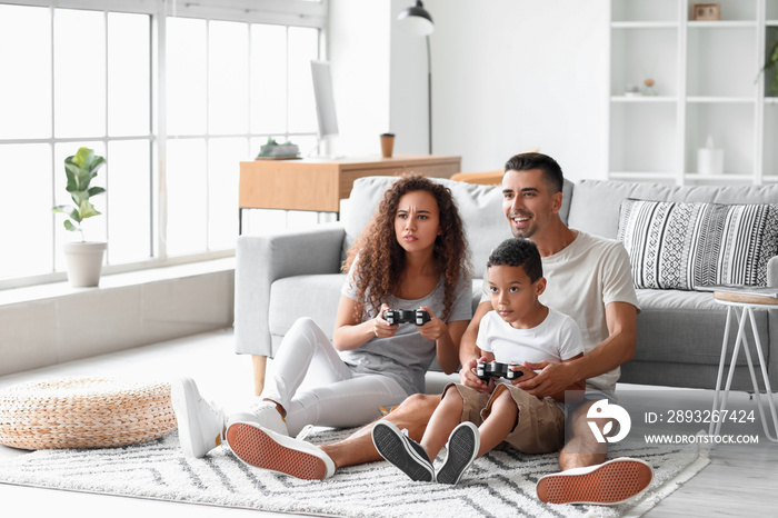 Happy interracial family playing video game at home