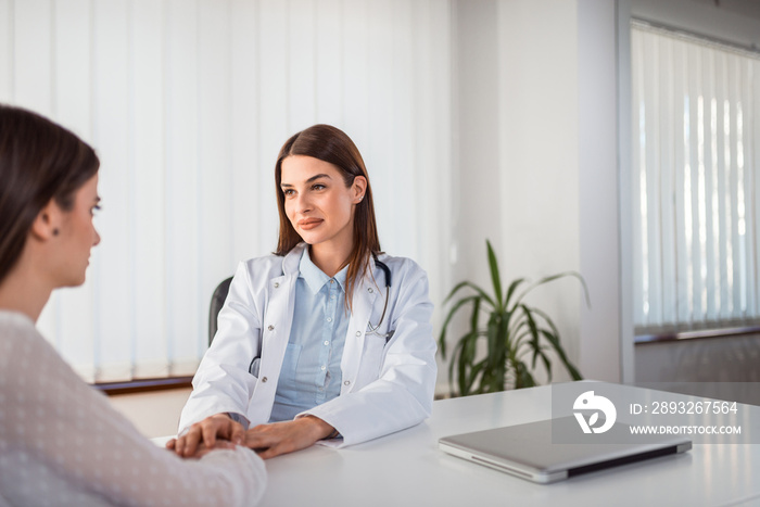 Young female doctor consulting and comforting a patient.