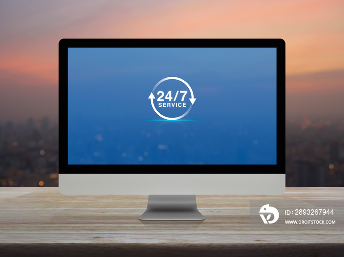 24 hours service flat icon on desktop modern computer monitor screen on wooden table over blur of ci