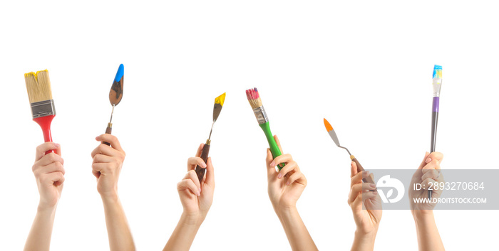 Female hands with painters supplies on white background