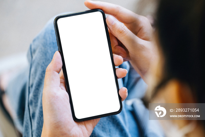 A woman holding a cell phone with a blank white screen. The blank space on the white screen can be u