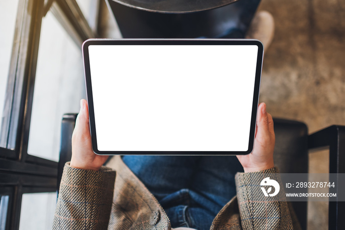 Top view mockup image of a woman holding black tablet pc with blank white screen