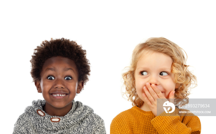 Two small children covering their mouths