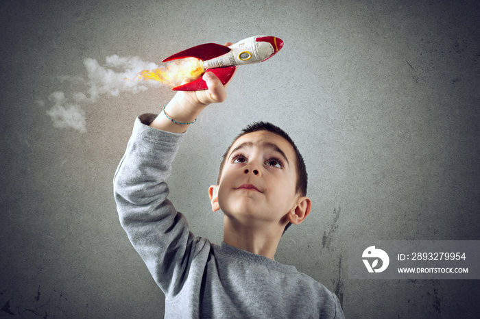 Child plays with a rocket. Concept of imagination