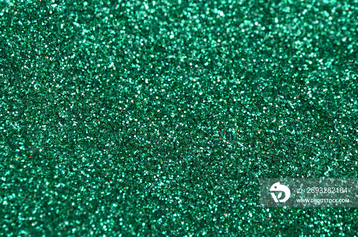 Colorful defocused emerald green background with glittering and sparkling spots