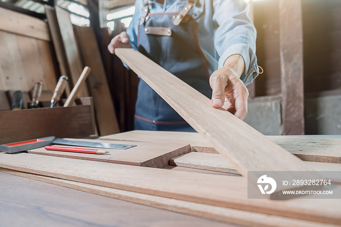 Carpenter working with equipment on wooden table in carpentry shop. woman works in a carpentry shop.