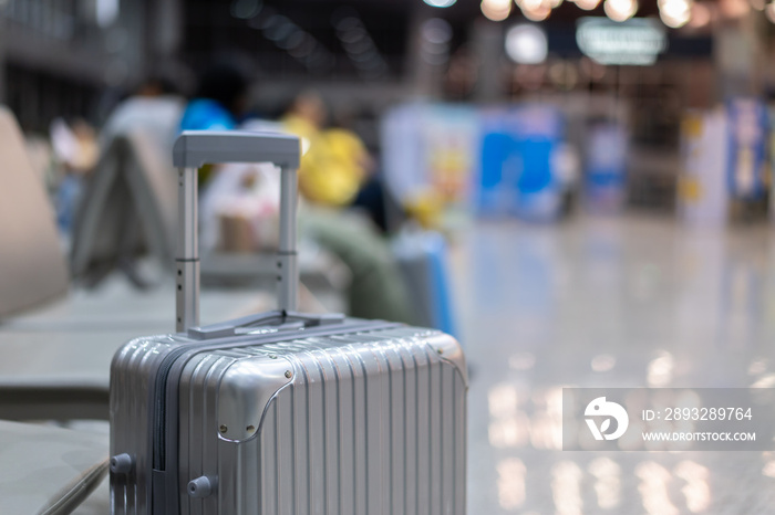 luggage holder on suitcase or bag with TRAVEL INSURANCE ,traveling luggages in an airport terminal,b