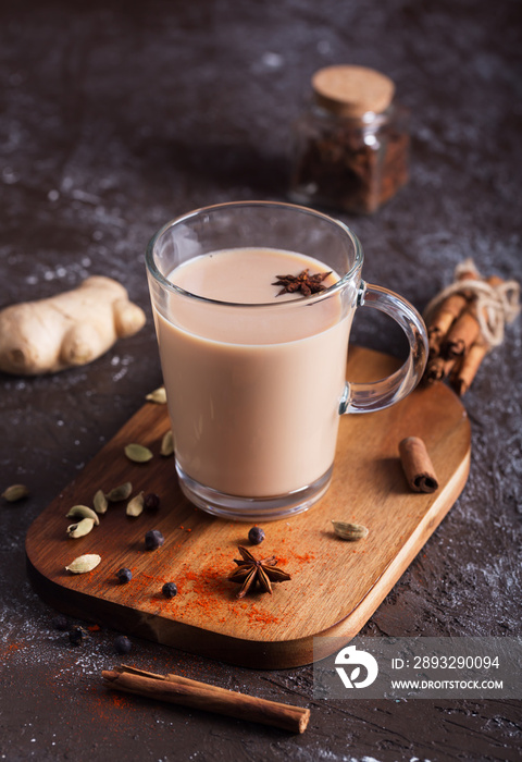 Masala chai tea on the dark background. Hot indian beverage with spices