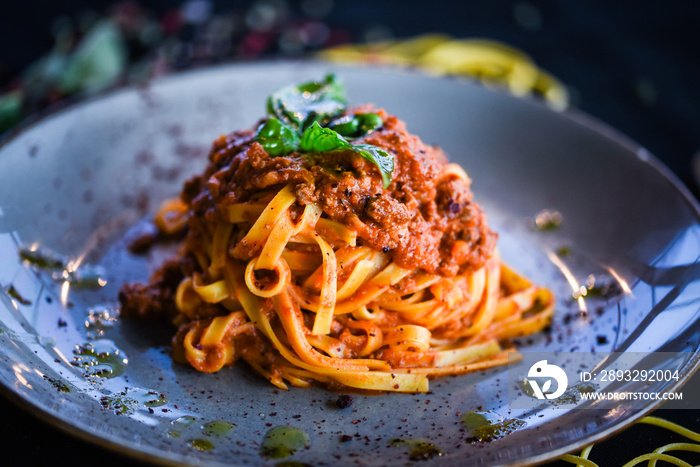 delicious italian spaghetti bolognese with minced beef sauce, tomatoes, carrots & fresh basil