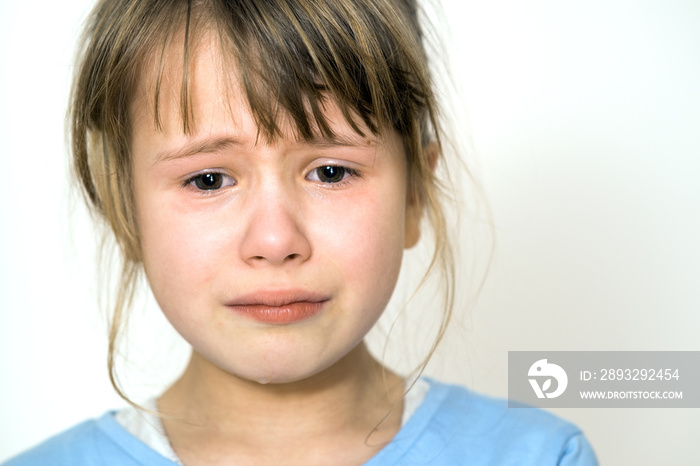 Closeup portrait of sad crying child girl.