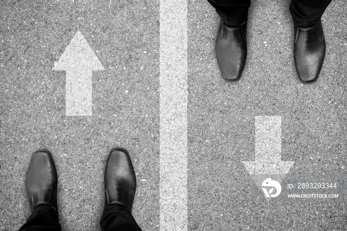 Two men standing on different side of the road