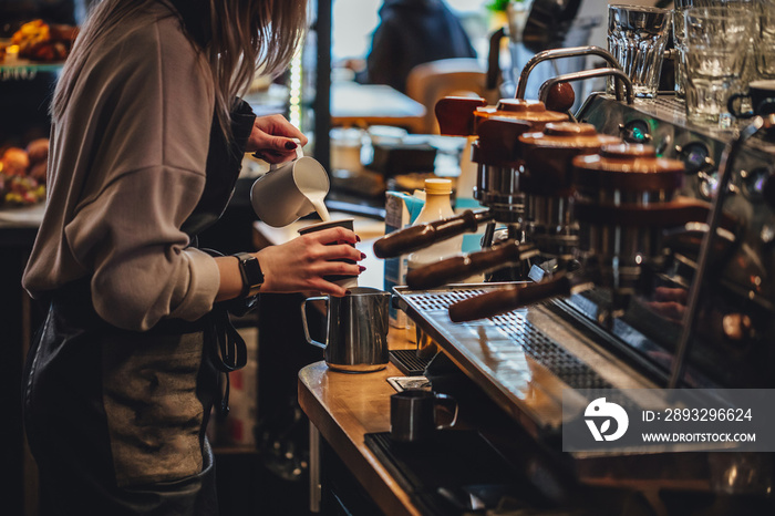 Barista making cappuccion coffee in coffee shop