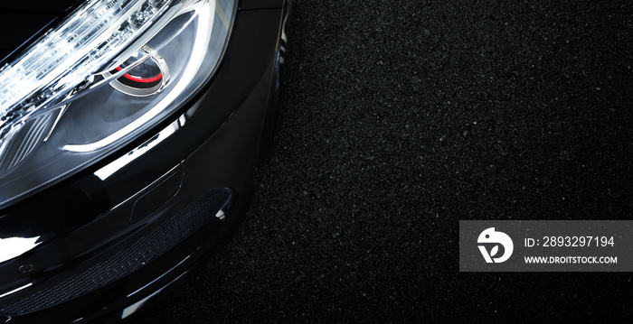 Top view of black modern car with asphalt road background