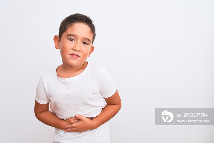 Beautiful kid boy wearing casual t-shirt standing over isolated white background with hand on stomac