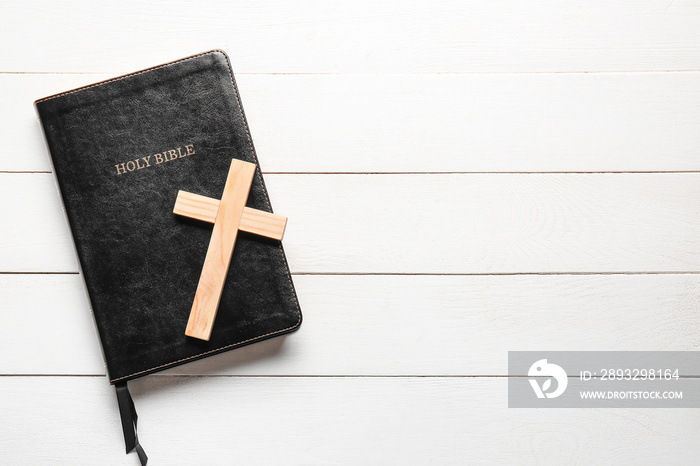 Holy Bible and cross on white wooden background