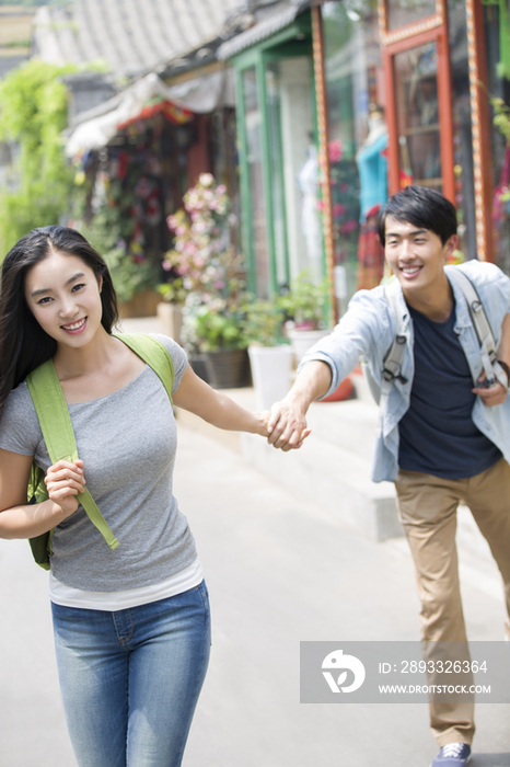 年轻情侣在北京胡同里旅游
