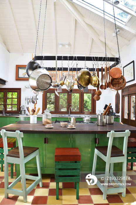 Utensils hanging over breakfast bar in kitchen