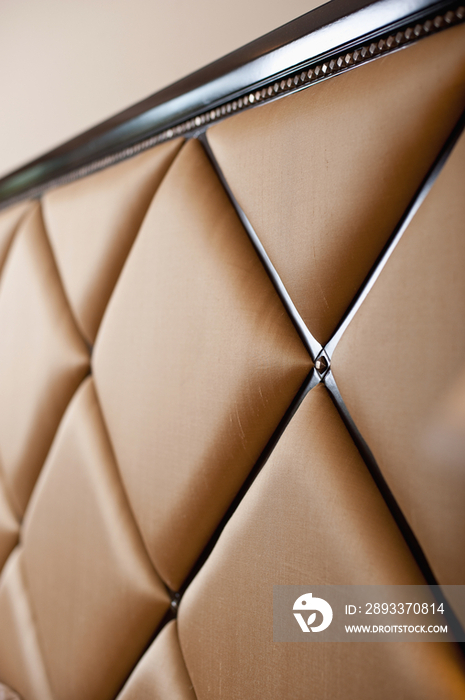 Extreme close-up of beige headboard