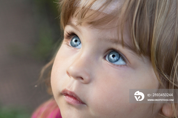 Close-up portrait of a beautiful child. Big Blue eyes