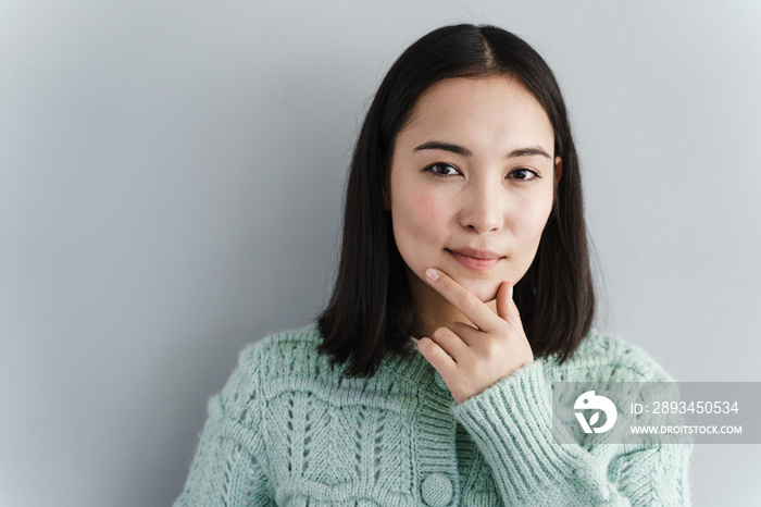 Portrait happy beautiful woman thinking looking up isolated grey wall background with copy space. Hu