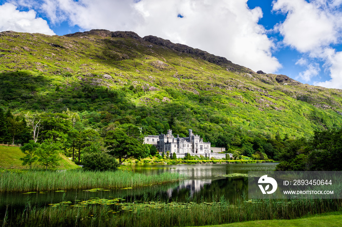 Kylemore Abbey with reflection in lake at the foot of a mountain. Connemara, Ireland