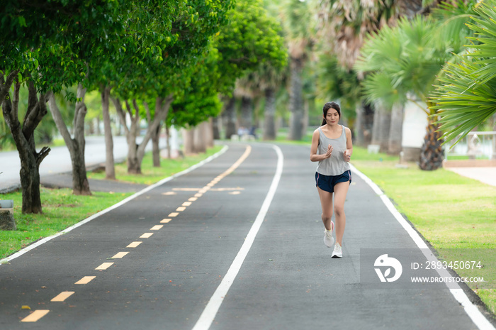 Asian beautiful woman running at the park,Thailand people,The runners run training for the competiti