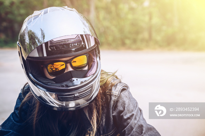 Confidence Asian woman wearing a motorcycle helmet before riding. Helmets contribute to motorcycle s