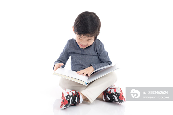 Cute asian boy reading a book on white background isolated