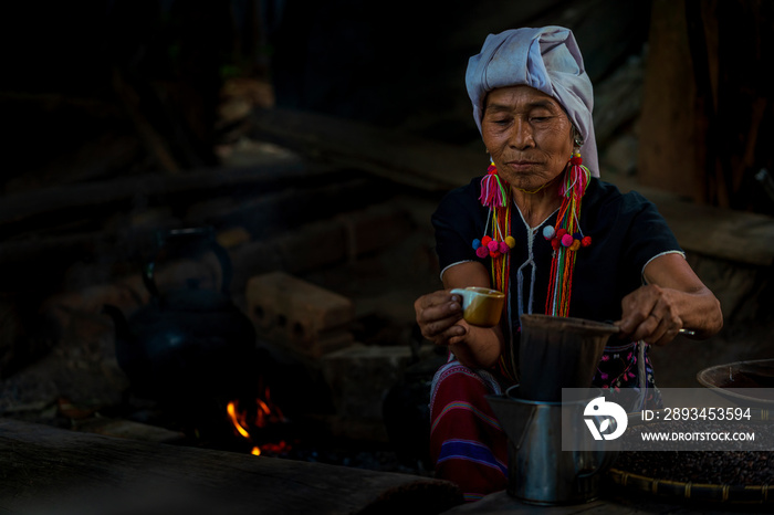 Hill tribe women drinking coffee. Ancient coffee brewing. Making Thai coffee and tea using coffee ba