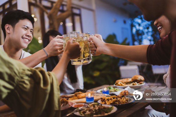 Group holiday party of asian people Eating dinner and drinking beer at home