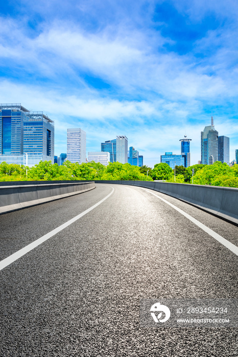 Empty asphalt road and Shanghai skyline with buildings scenery.