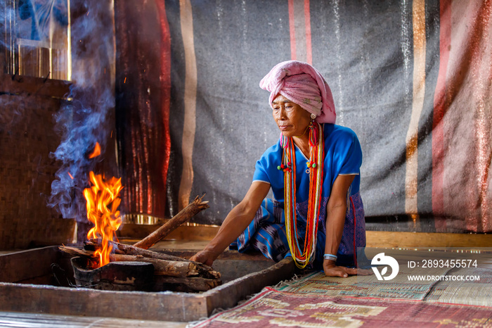 Old female karen hill tribe is cooking traditional in the cottage of northern Thailand at Mae Klang 