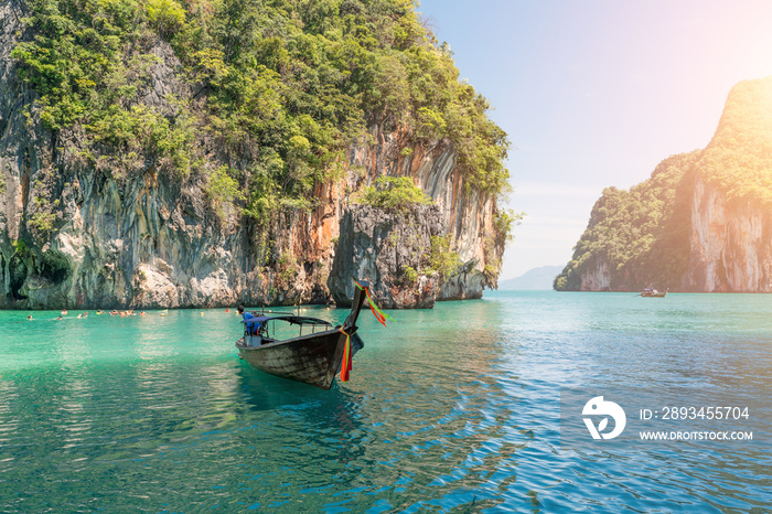 Beautiful landscape of rocks mountain and crystal clear sea with longtail boat at Phuket, Thailand. 