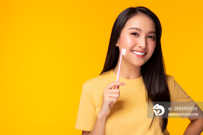 Happy woman take care tooth and holding toothbrush Young lady brushing her teeth Beautiful asian gir