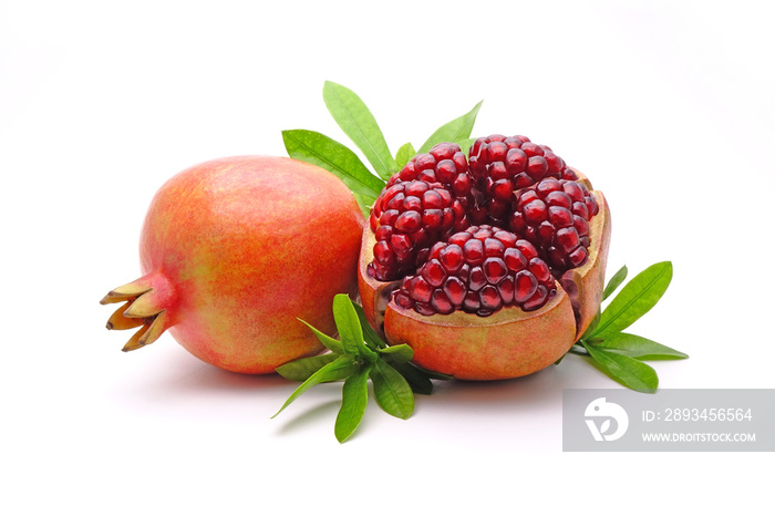 Pomegranate whole and cut with green leaves isolated on white background. Pomegranates (Punica grana