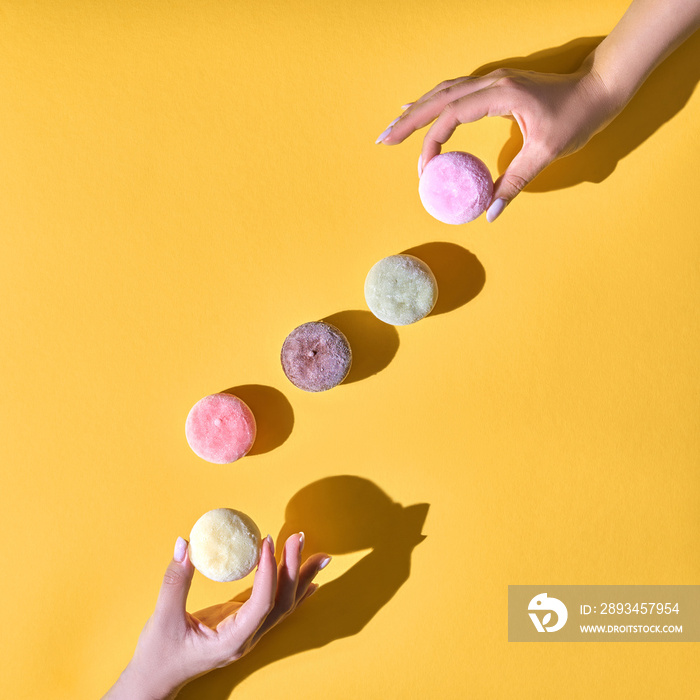 Japanese ice cream Mochi in rice dough. Traditional Japanese dessert on a yellow background.