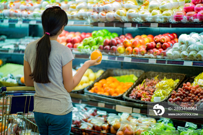 Woman are choosing fruit in supermarkets