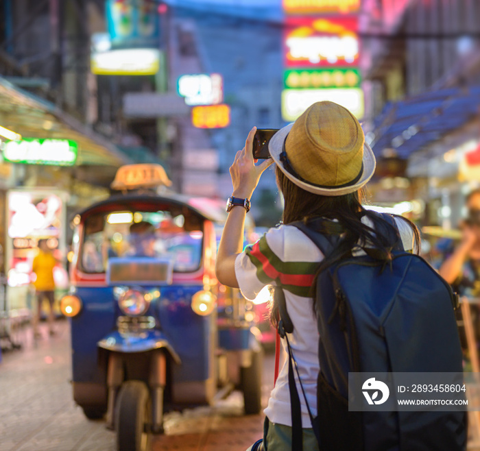 hand of woman tourist taking of shot photo in Chinatown of Bangkok, Yaowarat famous and popular plac