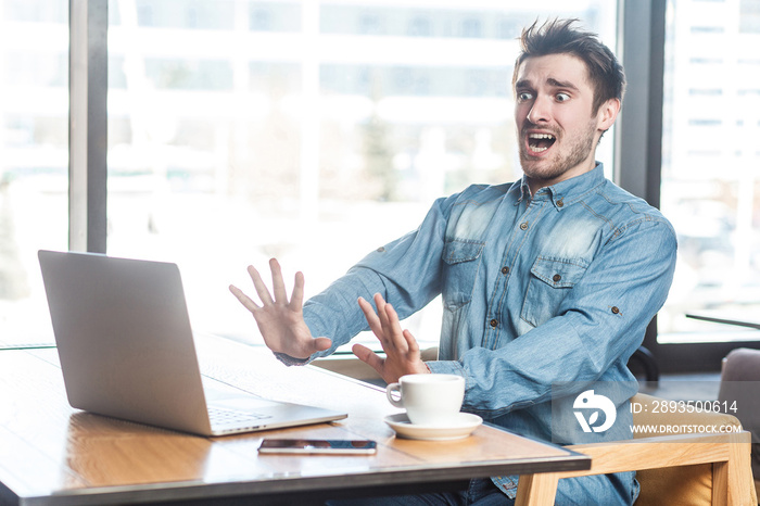 Crash! Side view portrait of emotional scared young businessman in blue jeans shirt are sitting in c