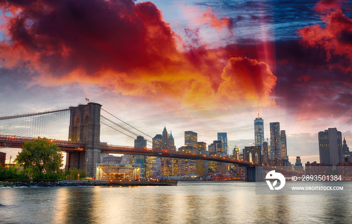 Manhattan skyline and Brooklyn Bridge view from Brooklyn Bridge Park at sunset, New York City