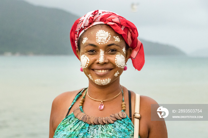 Portrait of a Malagasy woman with her face painted, Vezo-Sakalava tradition, Nosy Be, Madagascar.