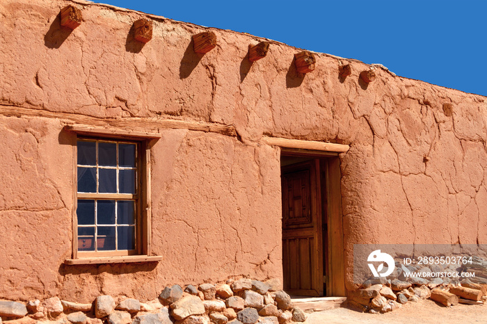 Rustic Santa Fe style adobe building with window door