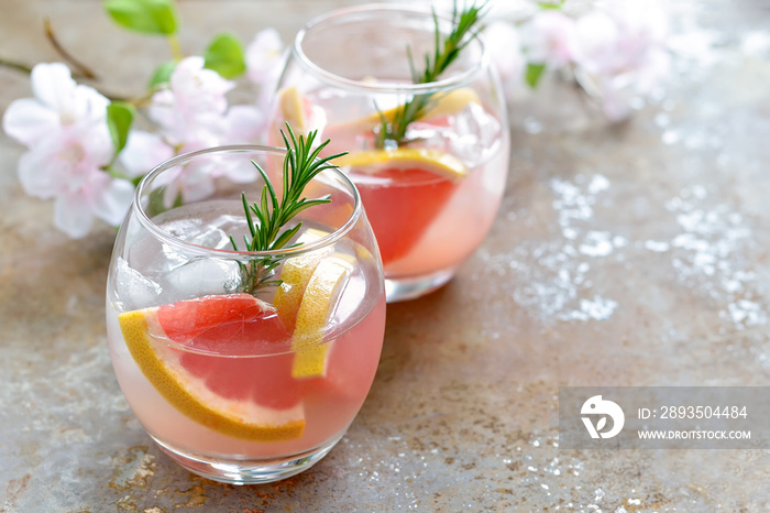 Grapefruit and rosemary drink, alcohol or non-alcohol cocktail or infused water with ice