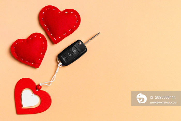 Top view of car key, wooden and textile hearts on colorful background. Saint Valentines Day concept