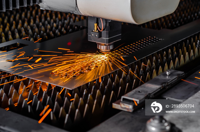 Laser machine cuts a metal sheet.