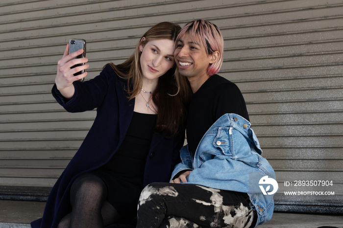 Lgbtqia friends sitting and posing together.